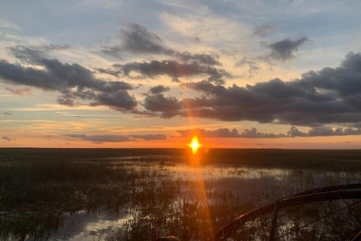 a sunset over a body of water with the sun setting