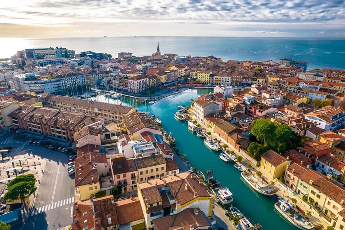 an aerial view of a city with boats in a river