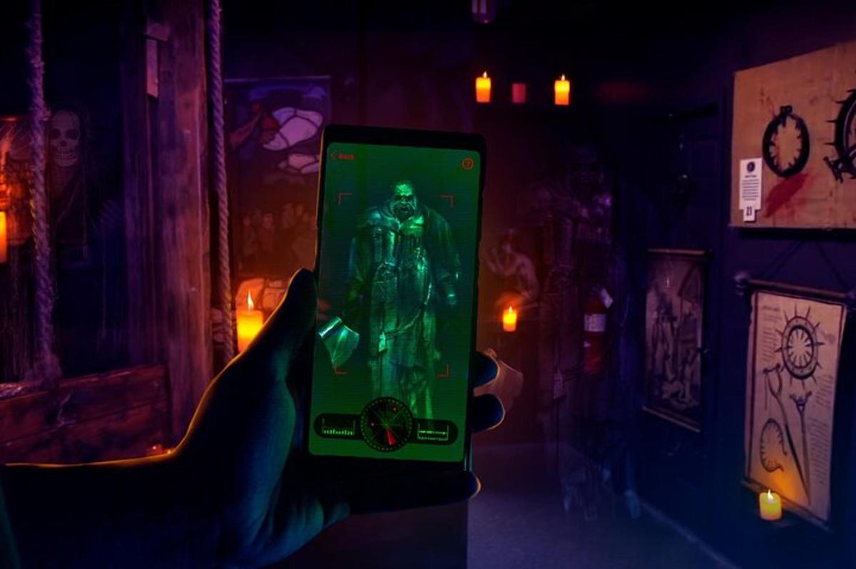 a person holding up a green object in a dark room