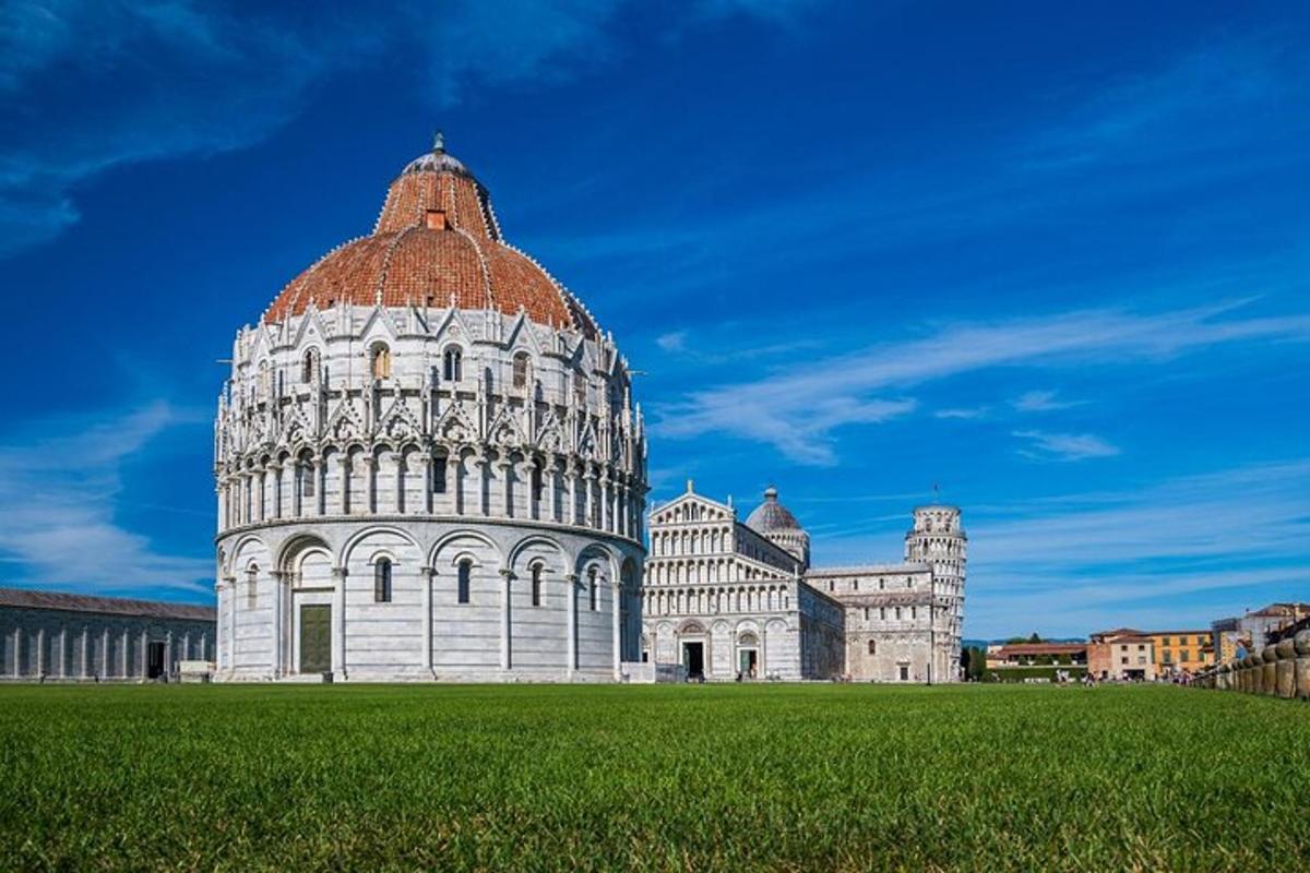 a building with a dome on top of a green field