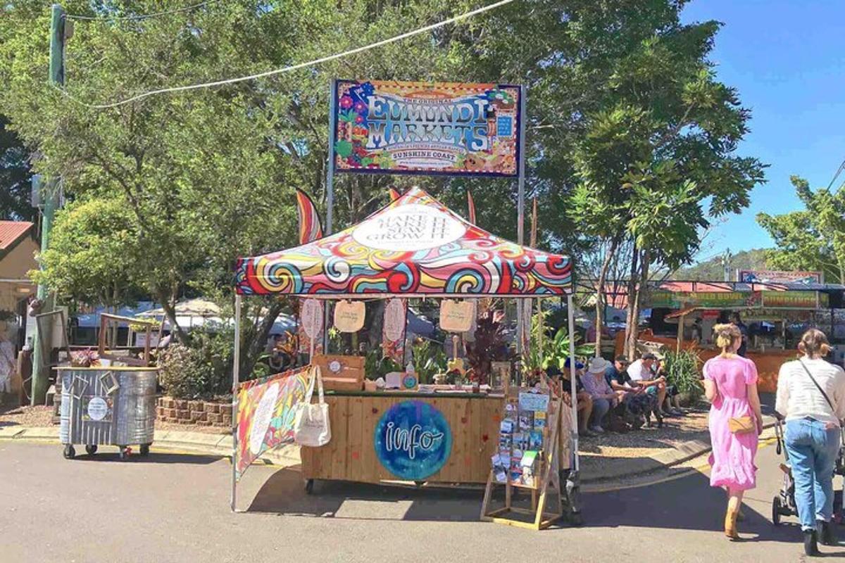 a carnival fair with a carousel in a park