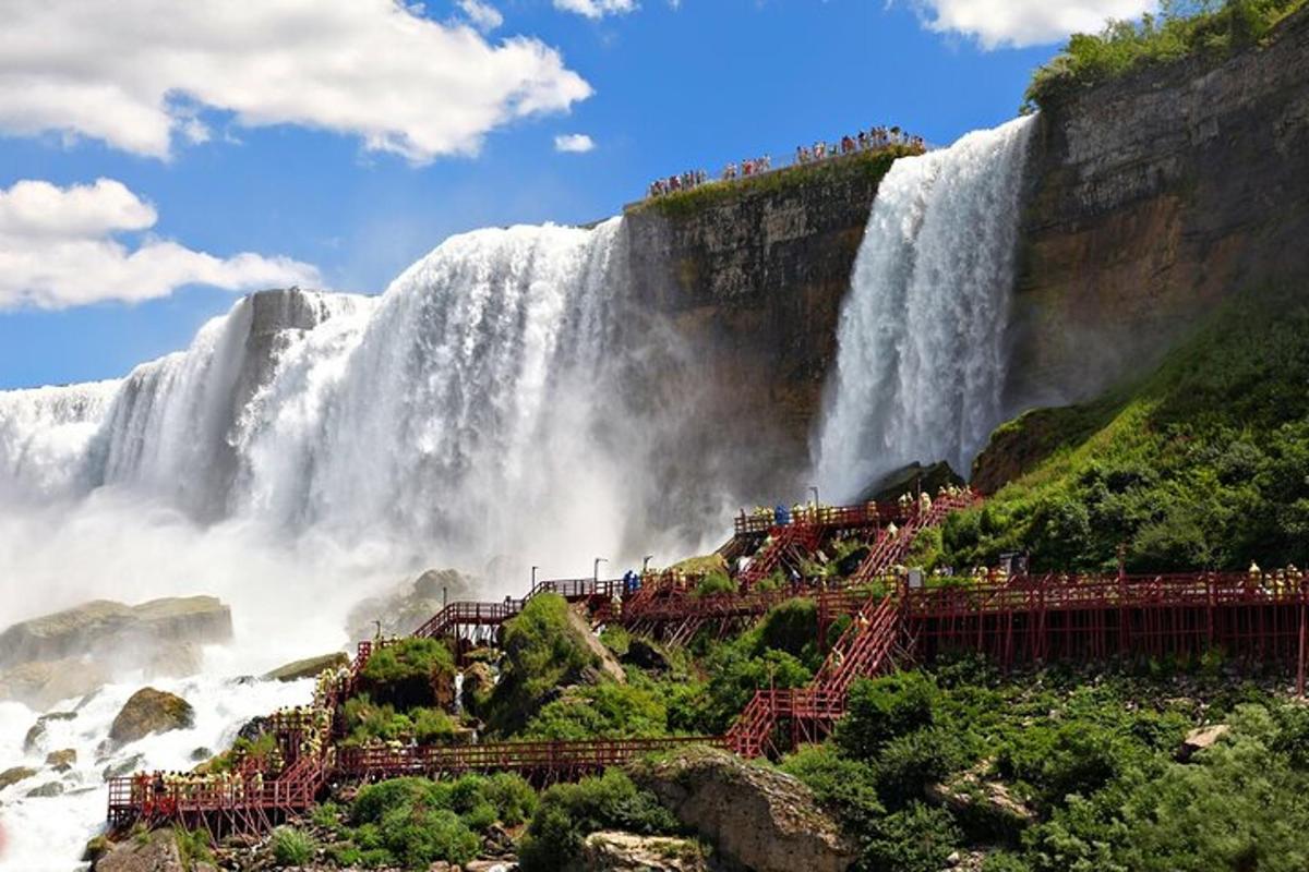 una vista di una cascata con persone in piedi su una scogliera