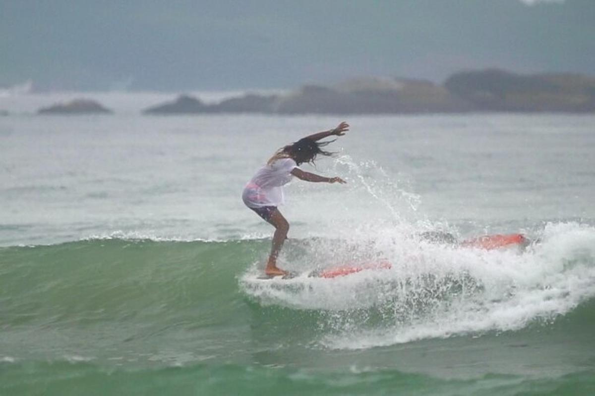 a girl riding a wave on a surfboard in the ocean