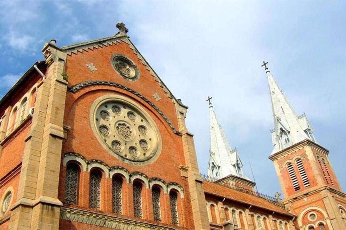 a large brick building with a clock tower and two spires