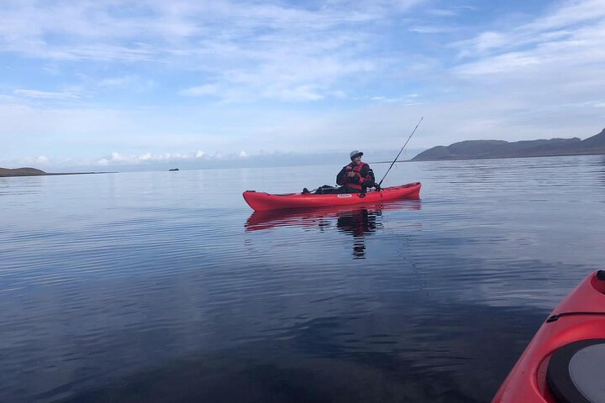 a man in a red kayak in the water