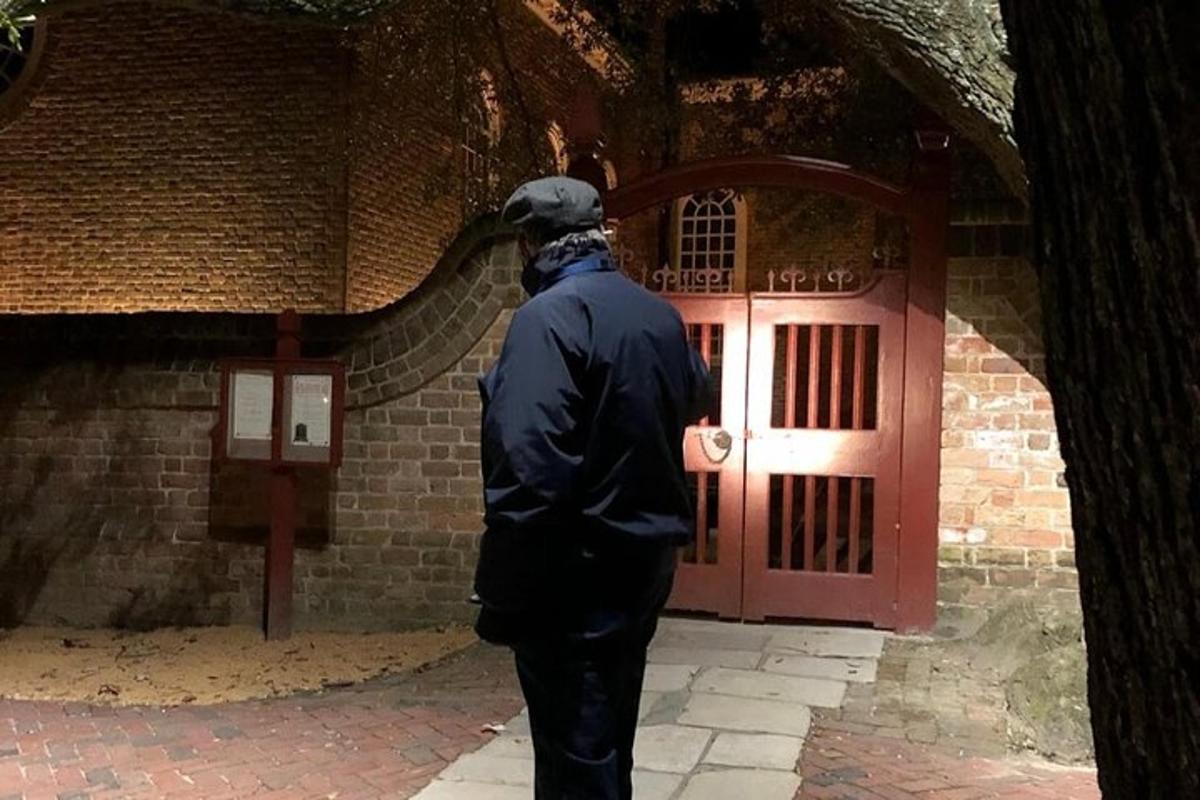 a man standing in front of a red door