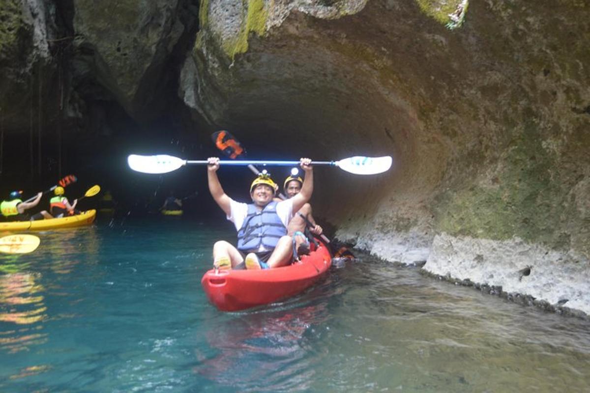 two people riding in a kayak in a cave