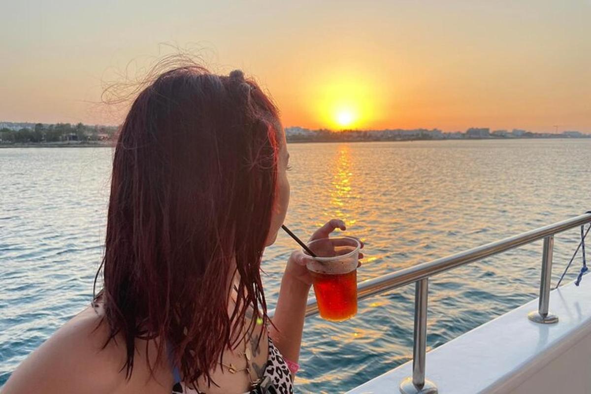 žena pije drink na lodi
