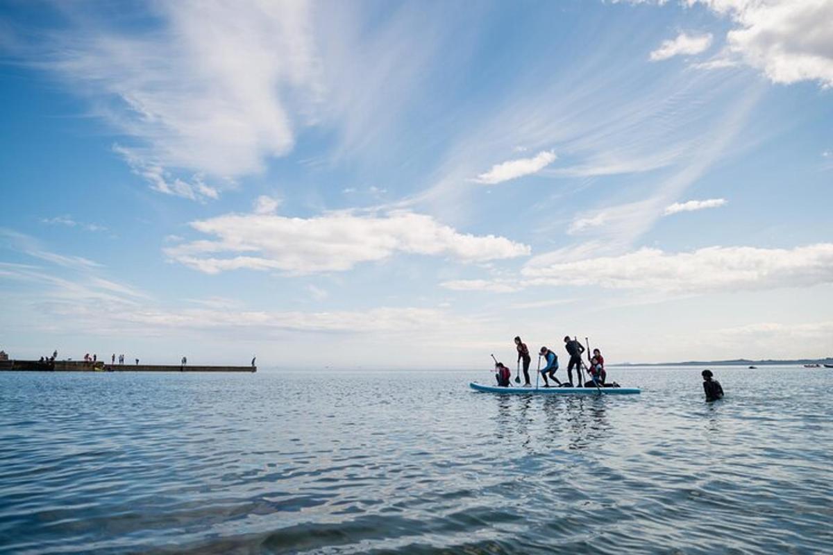 a group of people on a small boat in the water