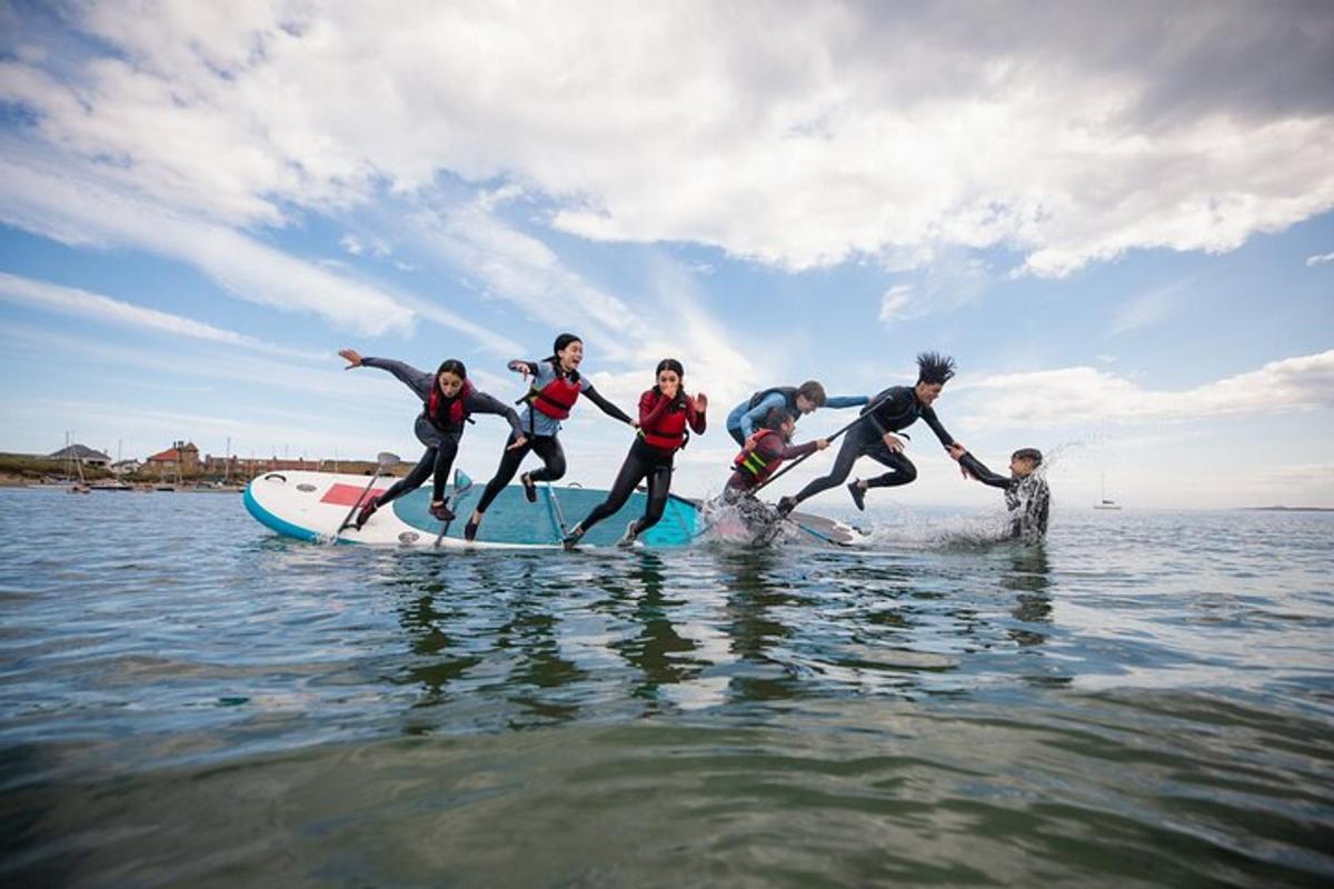 a group of people on a paddle board in the water