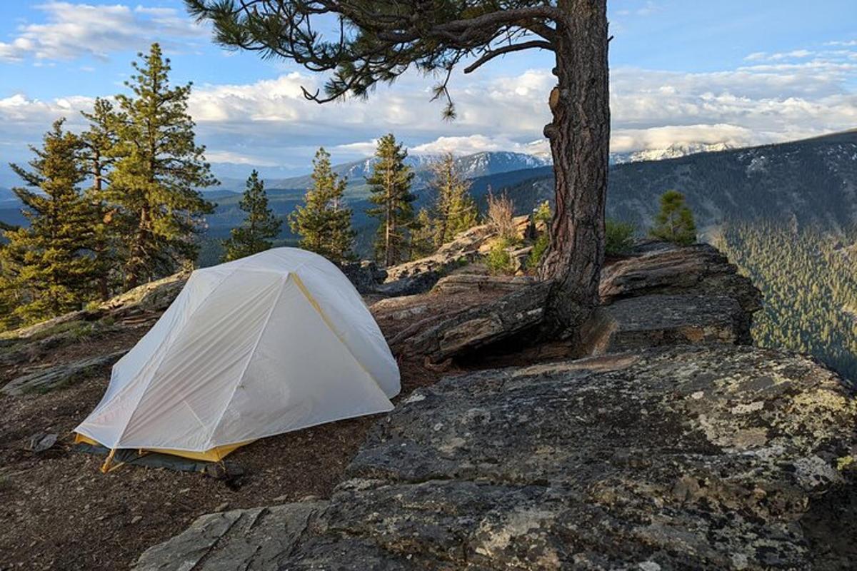a white tent sitting on top of a mountain