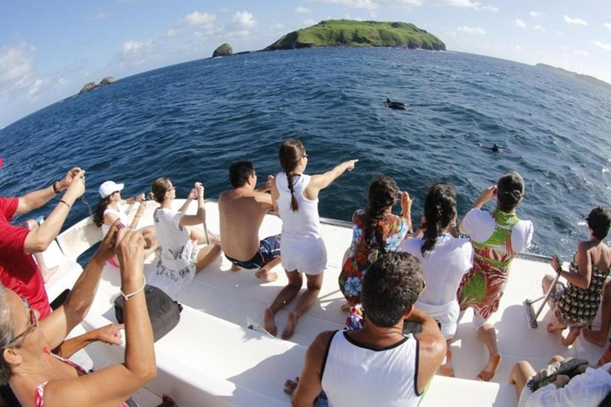 a group of people sitting on a boat in the ocean