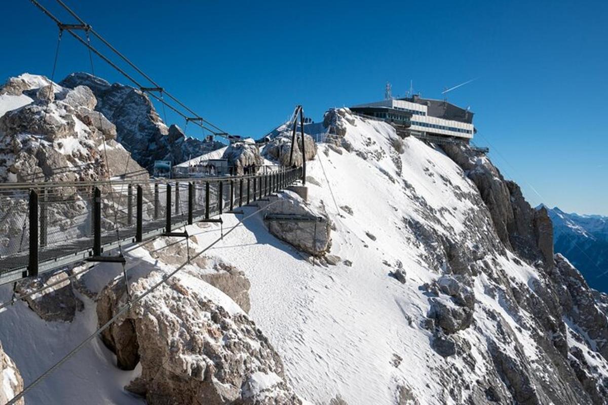 a snow covered mountain with a bridge on top of it