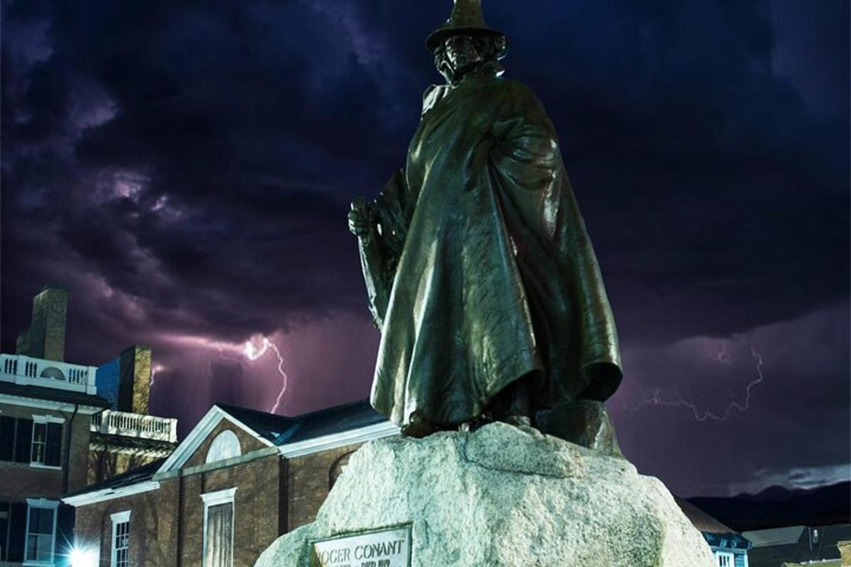 en statue af en mand, der står på toppen af en klippe