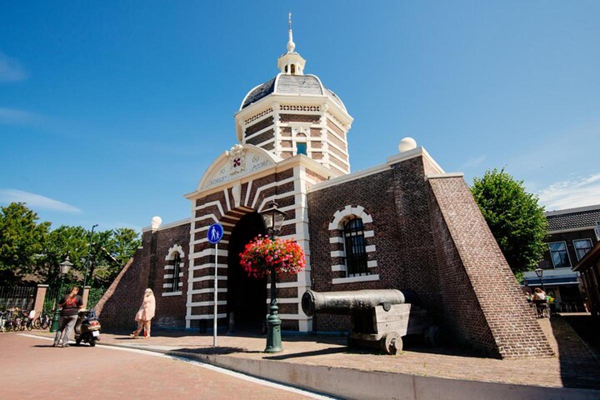 a small brick building with a tower on a street