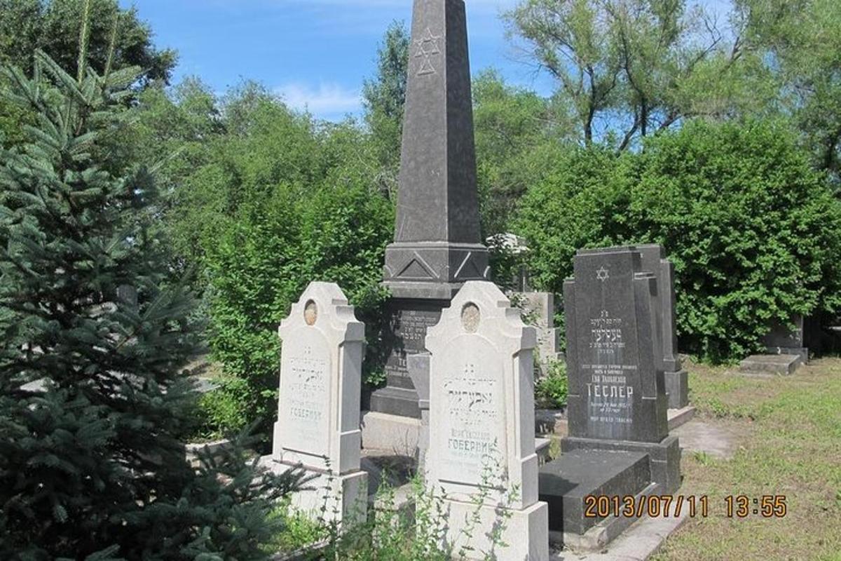 a large monument in a cemetery with tombstones