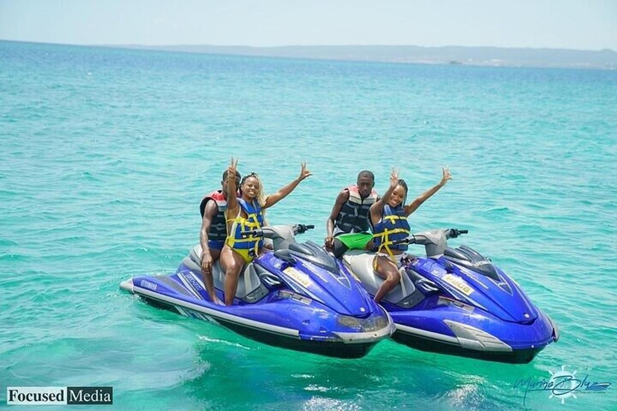 three people riding on a jet ski in the water