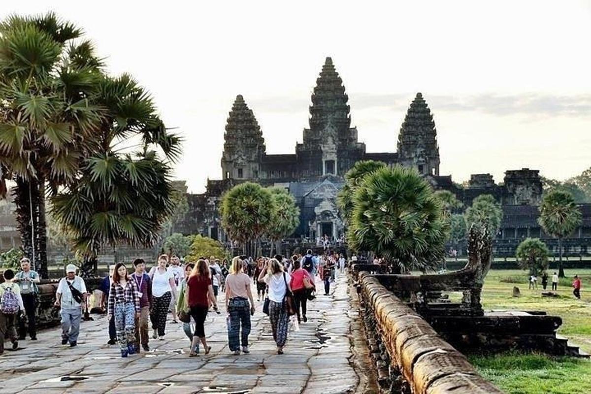 a group of people walking in front of a temple