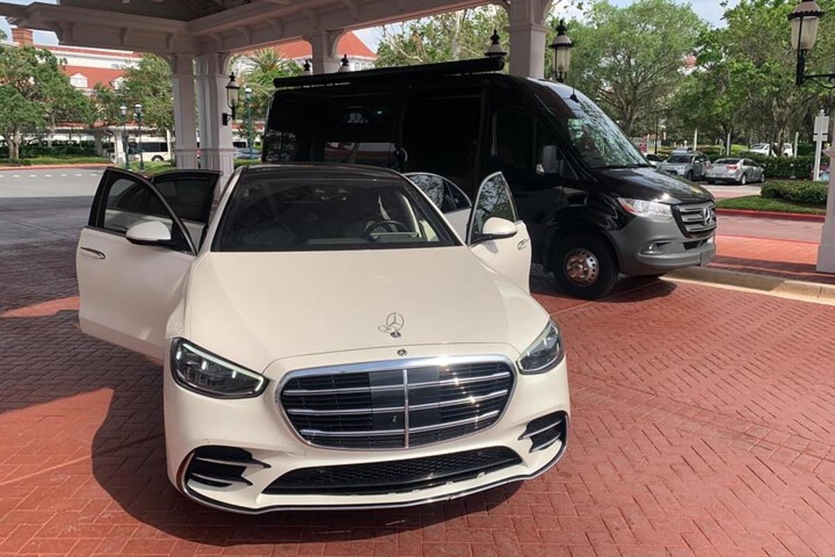 a white car parked in front of a van