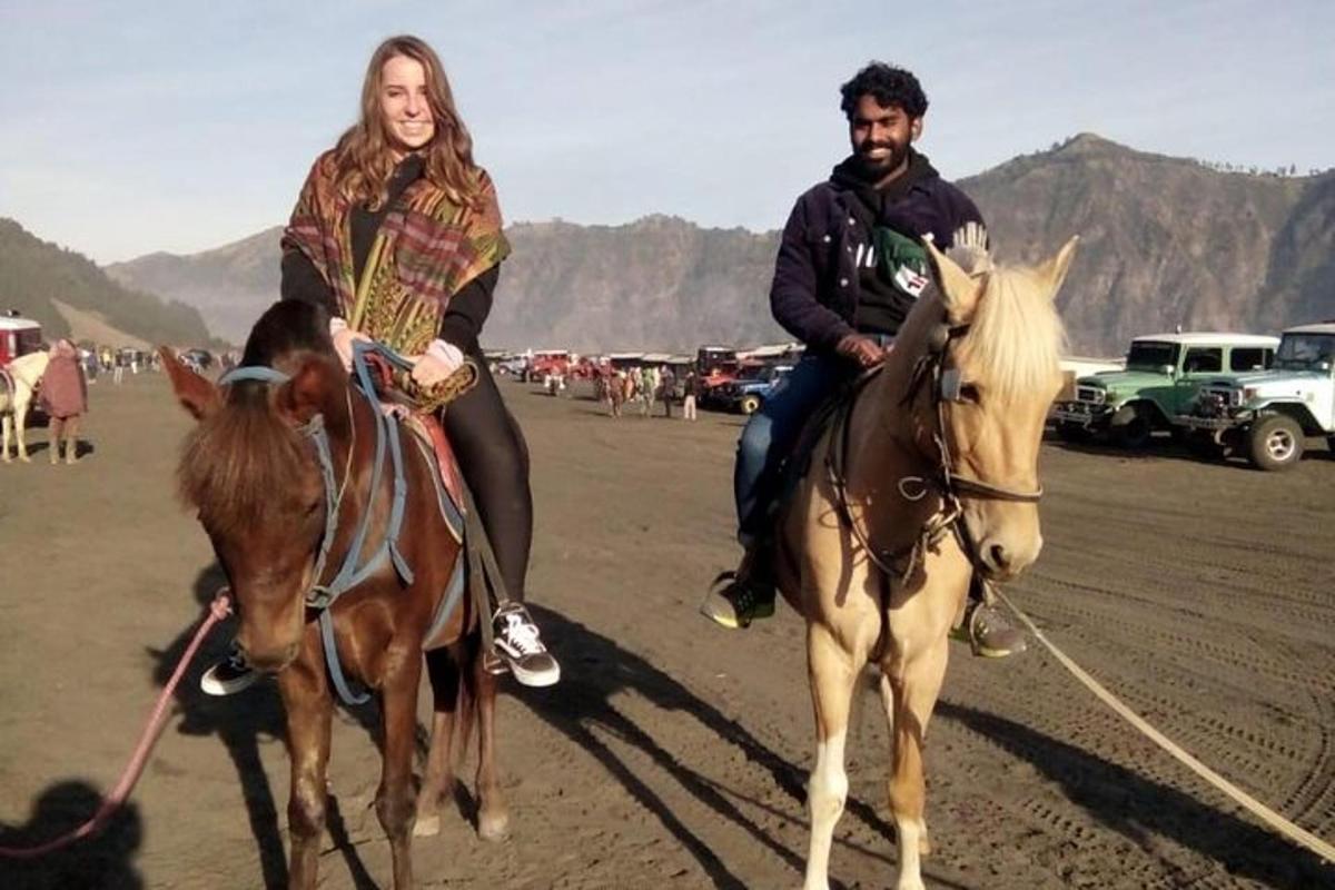 a man and a woman riding horses in the desert