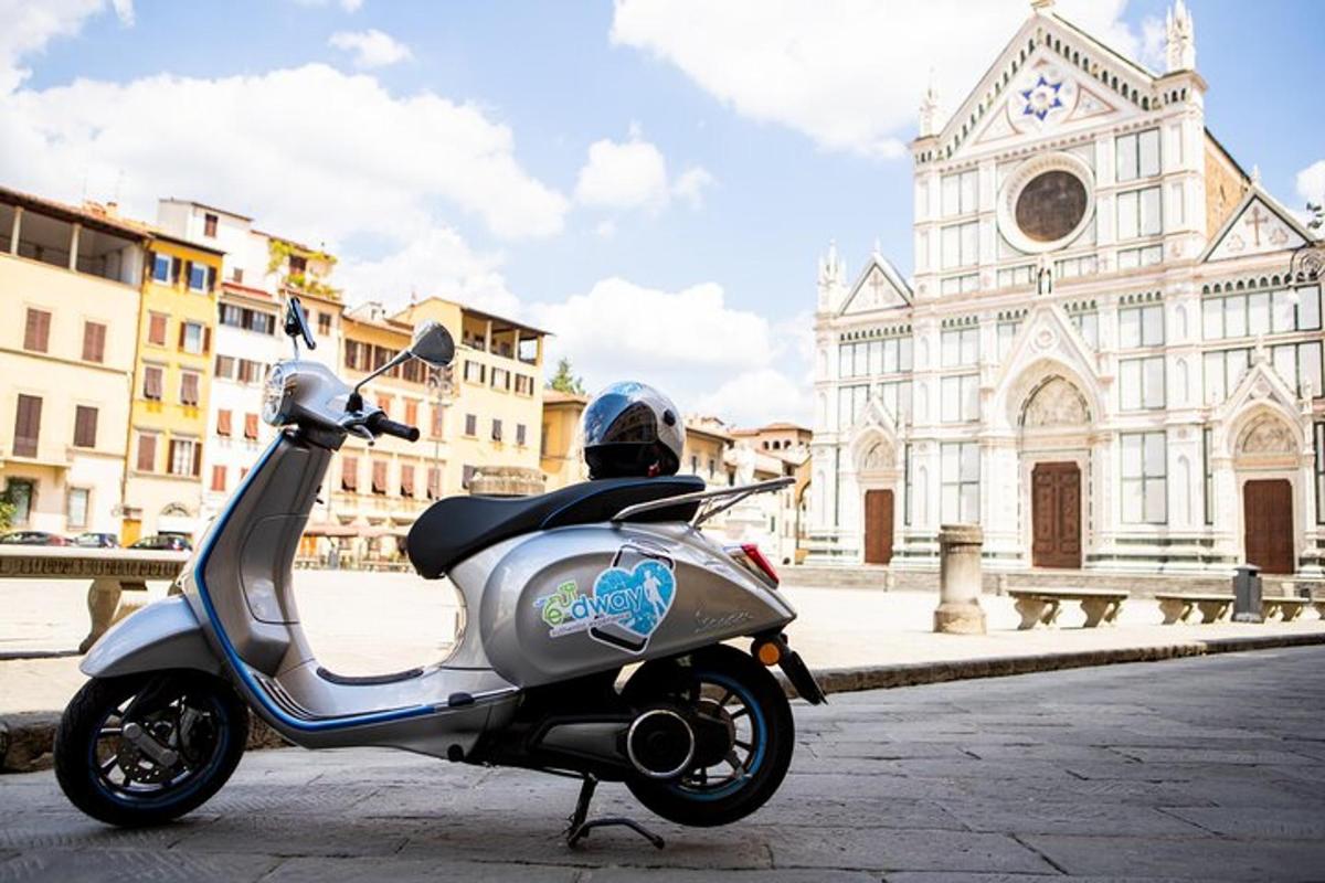a scooter parked on a street in front of a church