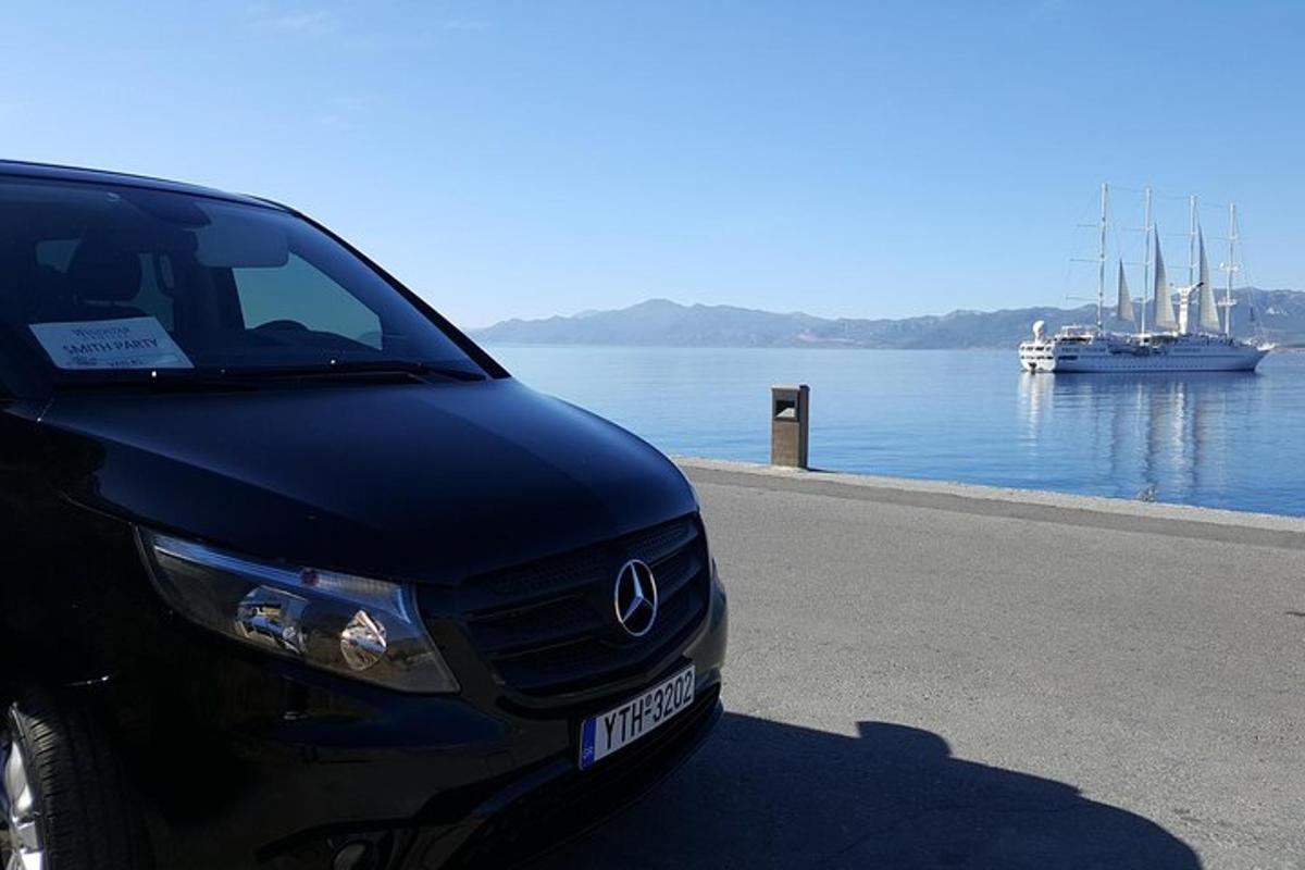 a black car parked next to a body of water