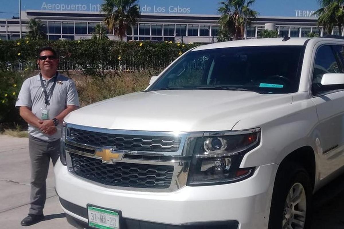 a man standing next to a white truck