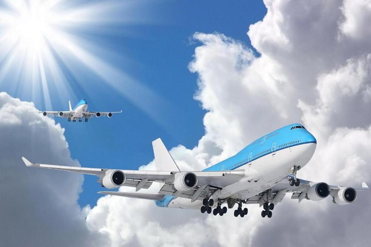 a blue and white airplane flying in the sky