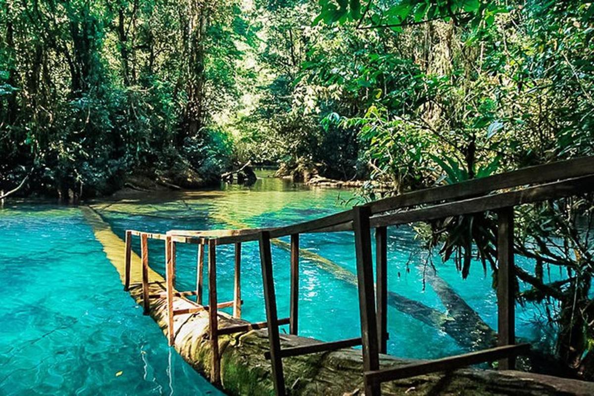 a bridge over a river with blue water