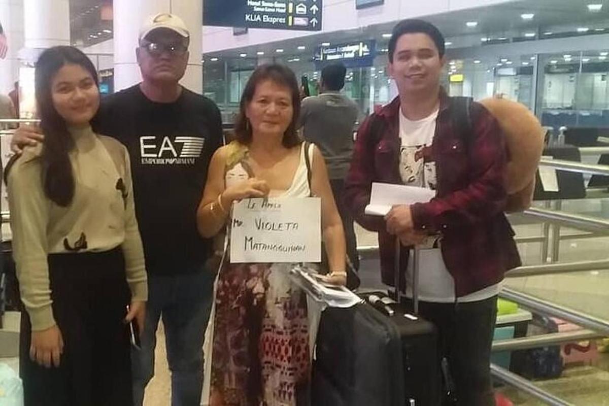 a group of people posing for a picture at an airport