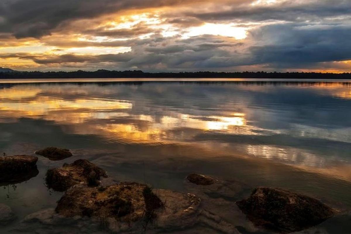 a large body of water with a cloudy sky