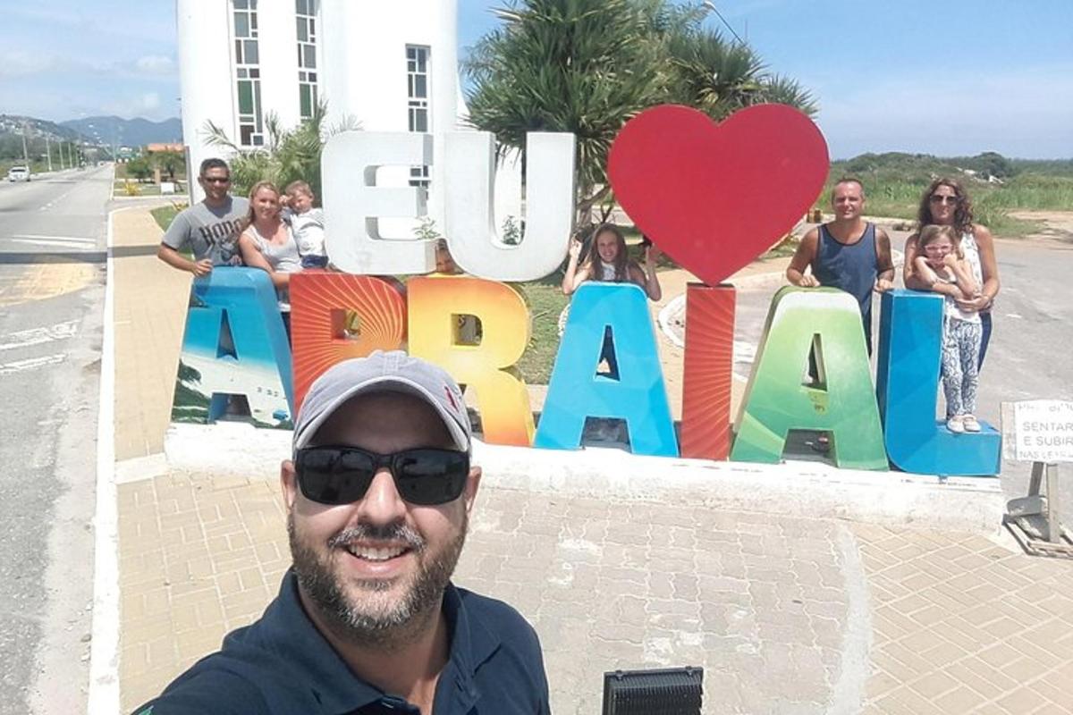 a man standing in front of a sign that says cuba
