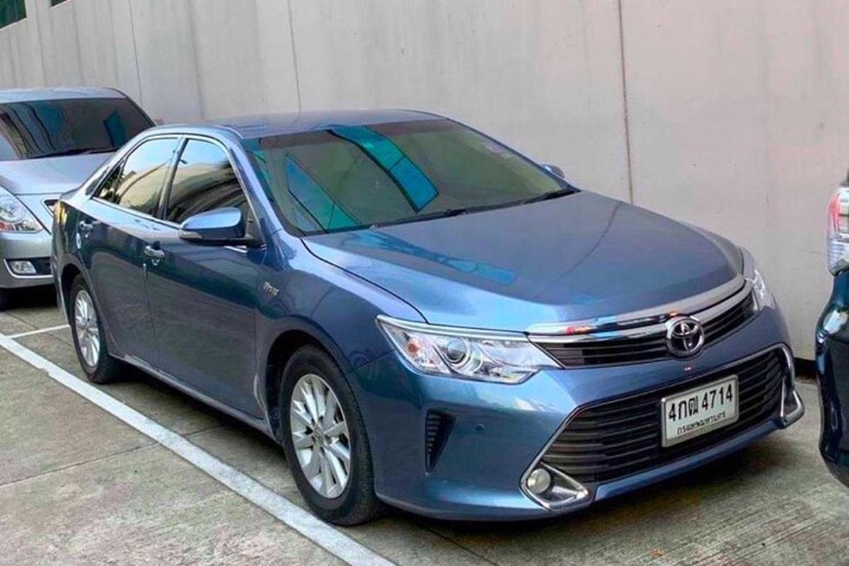 a blue car parked in a parking lot