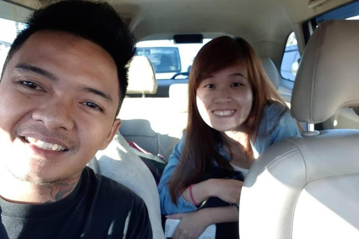 a man and a woman sitting in a car