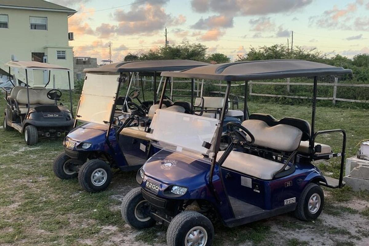 a couple of golf carts parked in a field