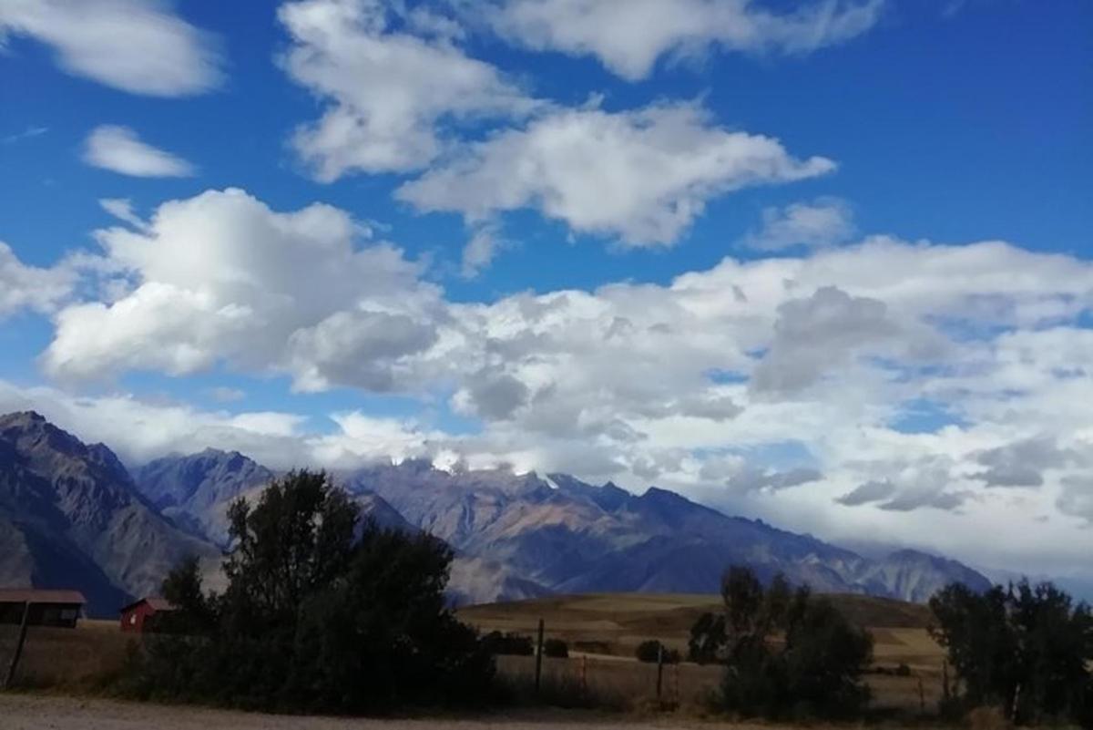 a view of mountains with a blue sky and clouds