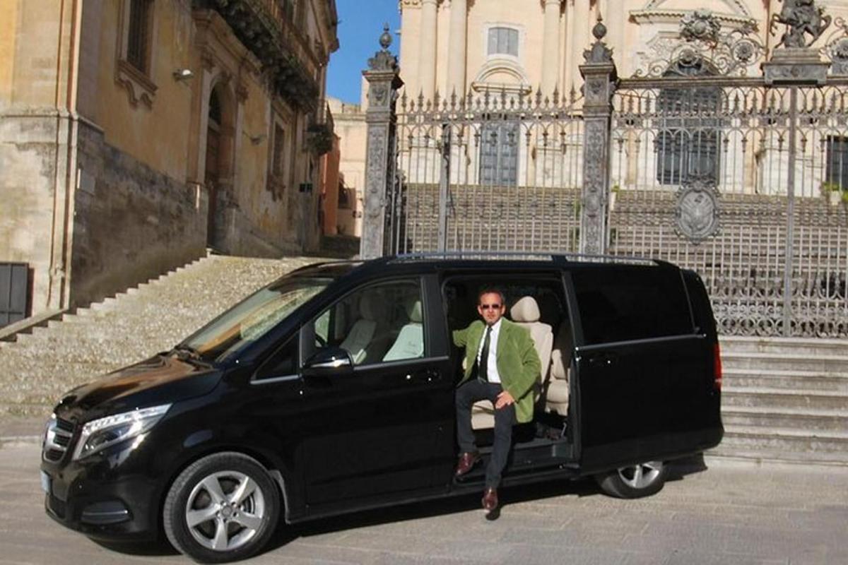 um homem sentado na parte de trás de uma van preta