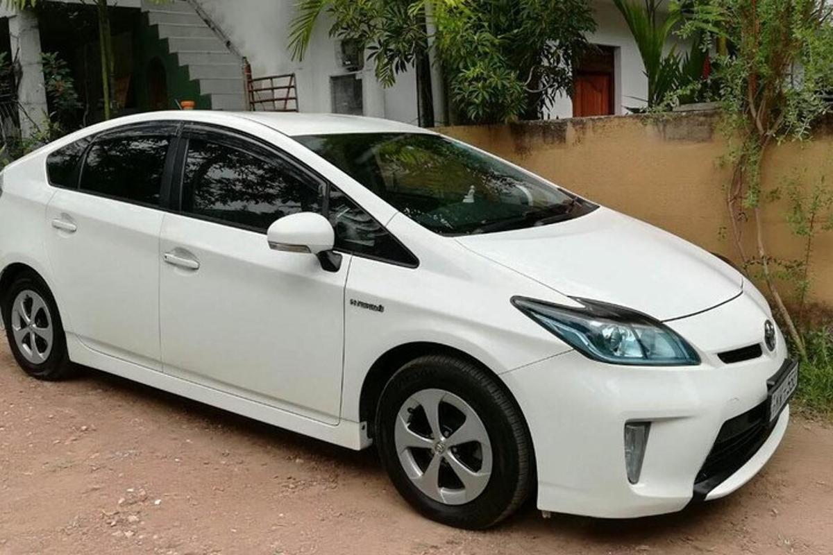a white car parked in front of a house
