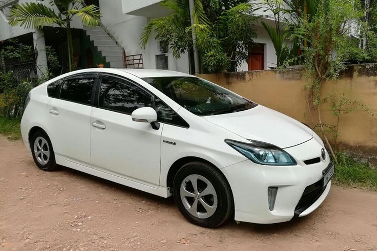 a white car parked in front of a house
