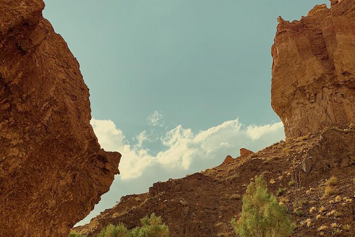 a view of a rocky canyon with the sky in the background