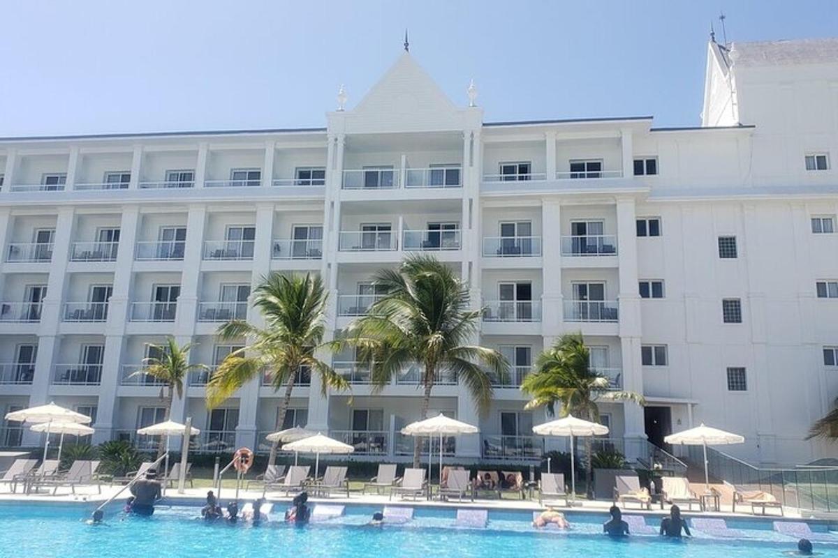 a hotel with a swimming pool in front of a building