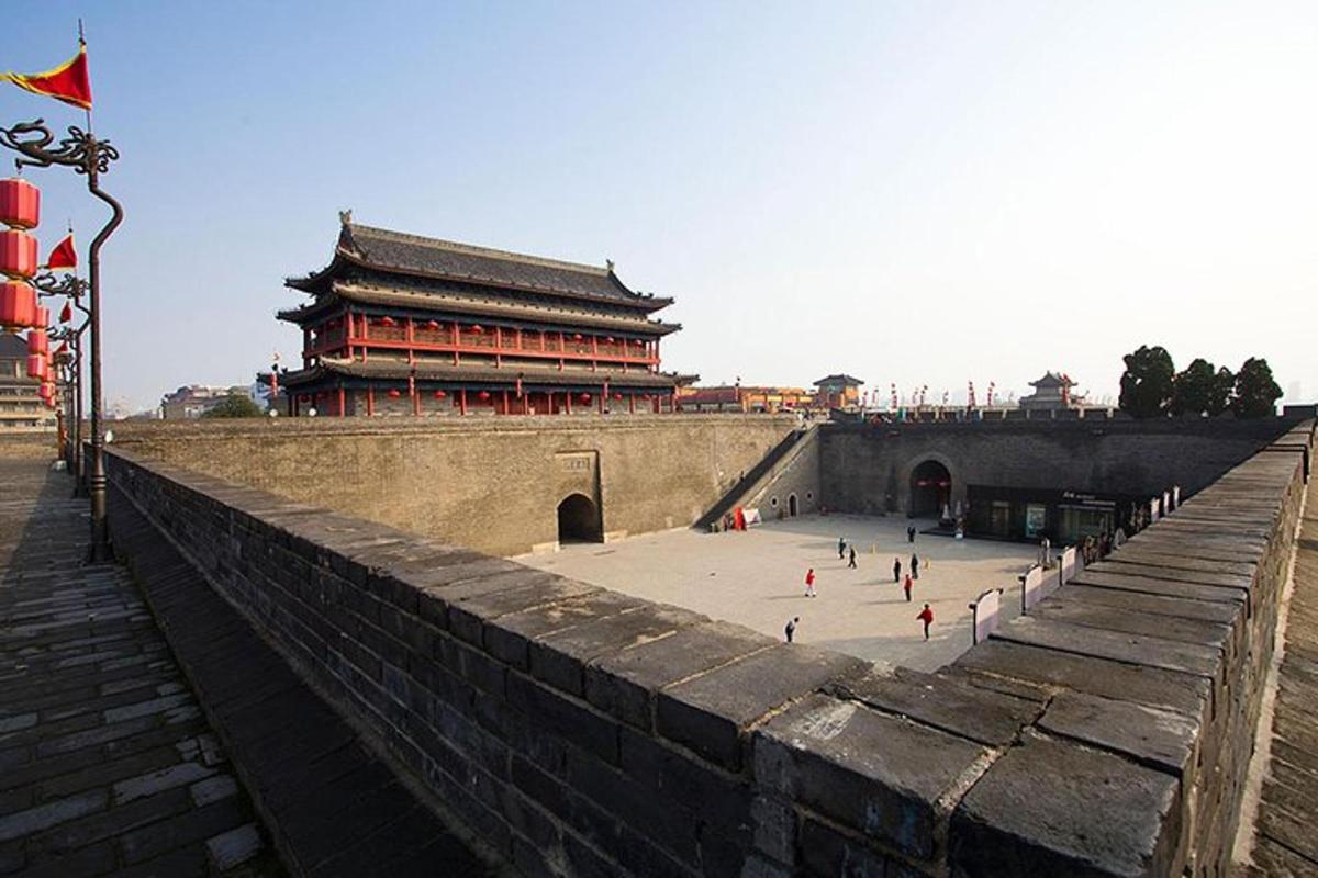 a large wall with a building in the background