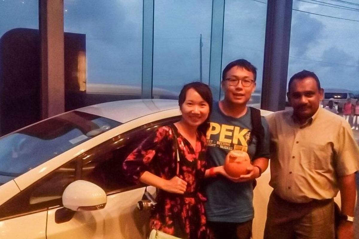 một nhóm ba người đứng cạnh một chiếc xe hơi