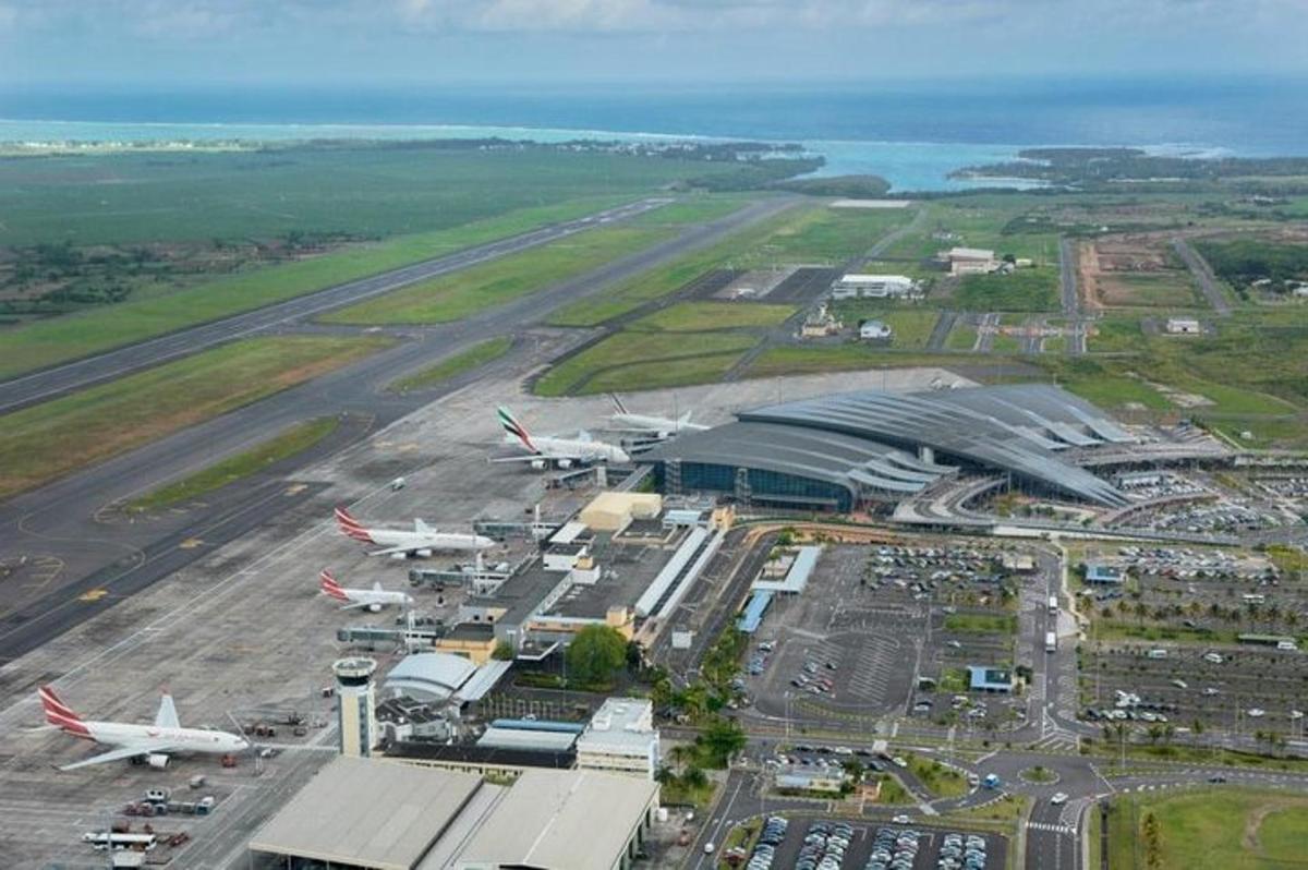 an aerial view of an airport with planes on the runway