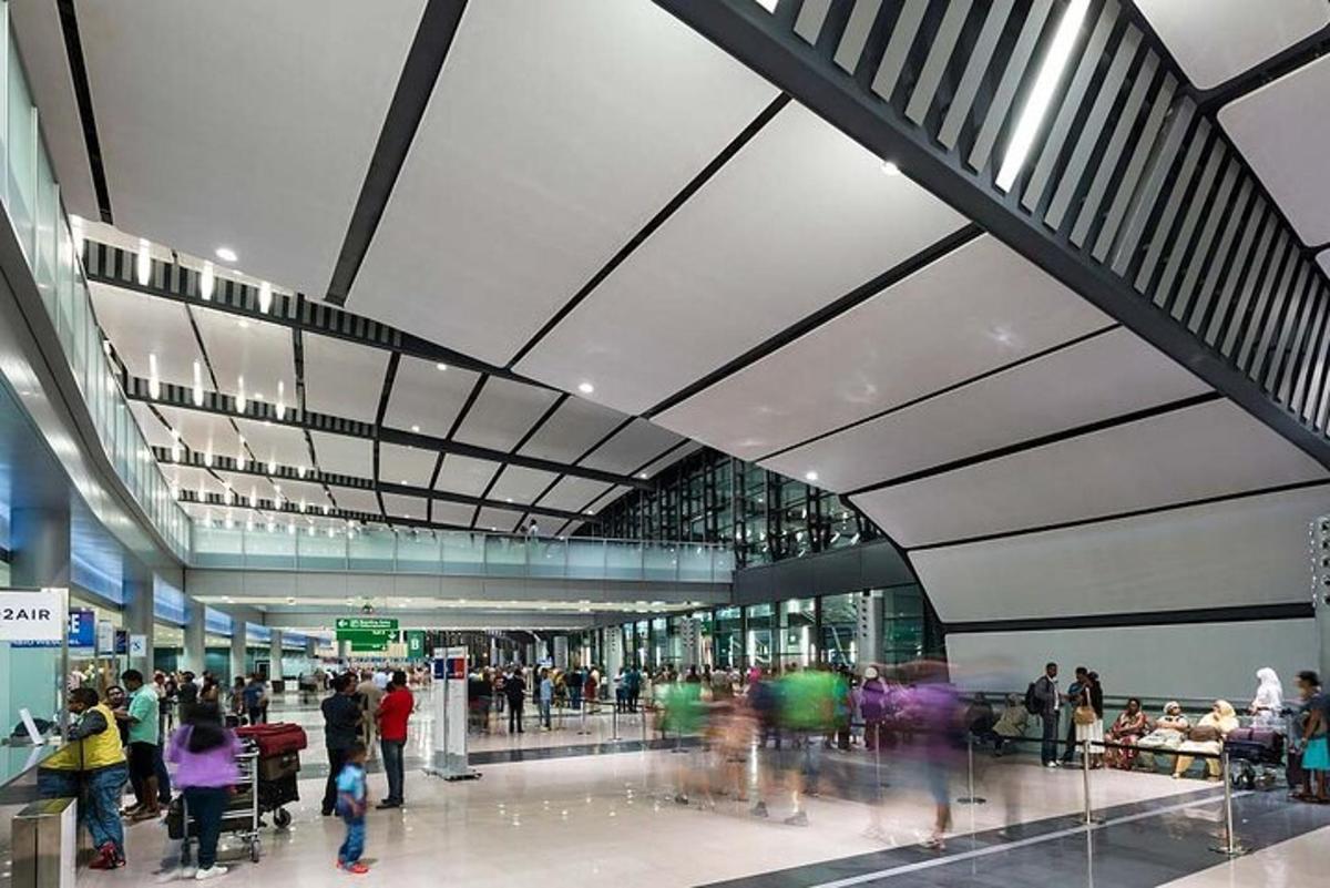 a group of people walking around an airport