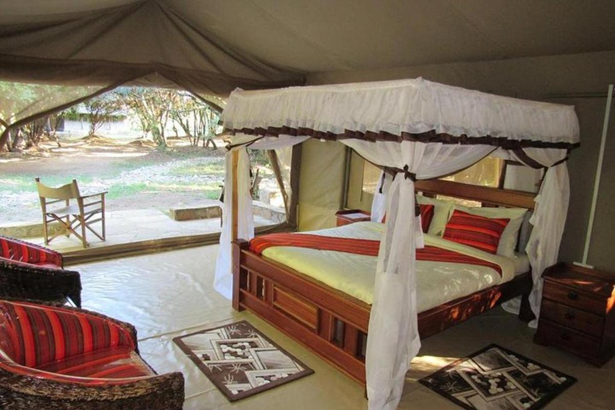a bedroom with a canopy bed and a chair