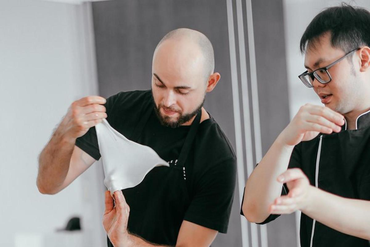 a man holding a piece of paper next to another man