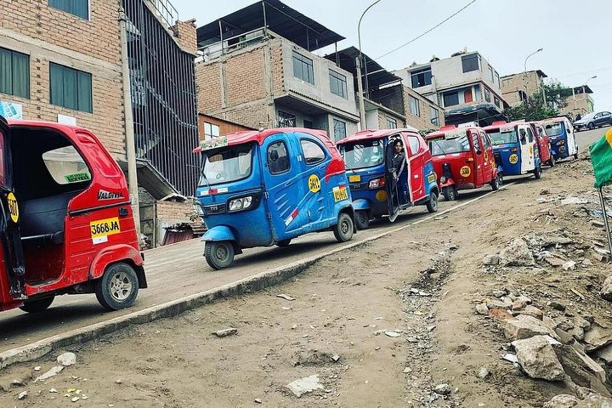 a row of small cars parked on the side of a street