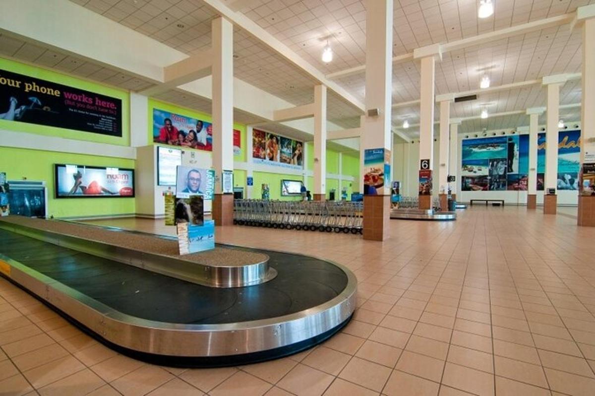a large airport with a luggage carousel in the middle