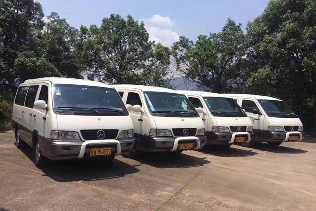 a row of white vans parked in a parking lot